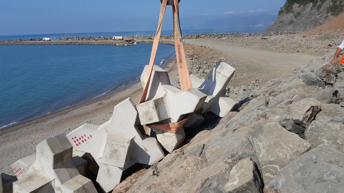 Kıyı yapısında yerine indirilen askıdaki beton koruma elemanı