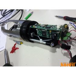 Technician inspecting a positioning sensor