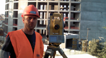 Construction surveyor using a total station
