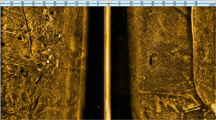 Side-scan sonar seabed inspection showing contacts, linear features and acoustic shadows.