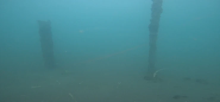 Underwater view of a vertical structure during seabed inspection