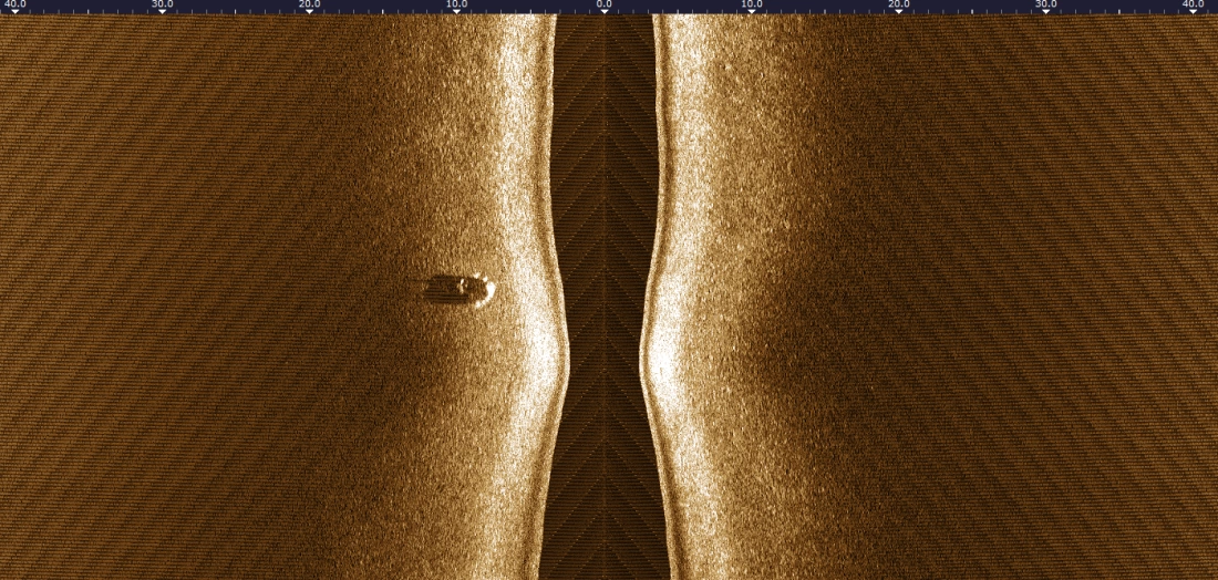 Side-scan sonar record showing an isolated seabed target and its acoustic shadow